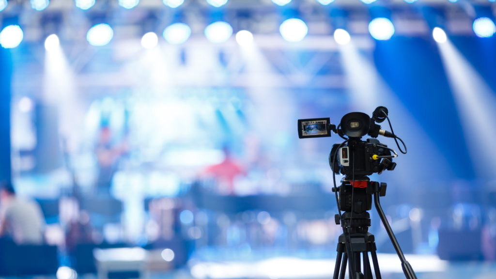 a camera pointing towards a bright stage