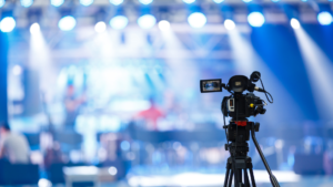 a camera pointing towards a bright stage